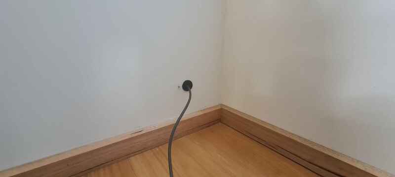 A cord in a hole in the wall